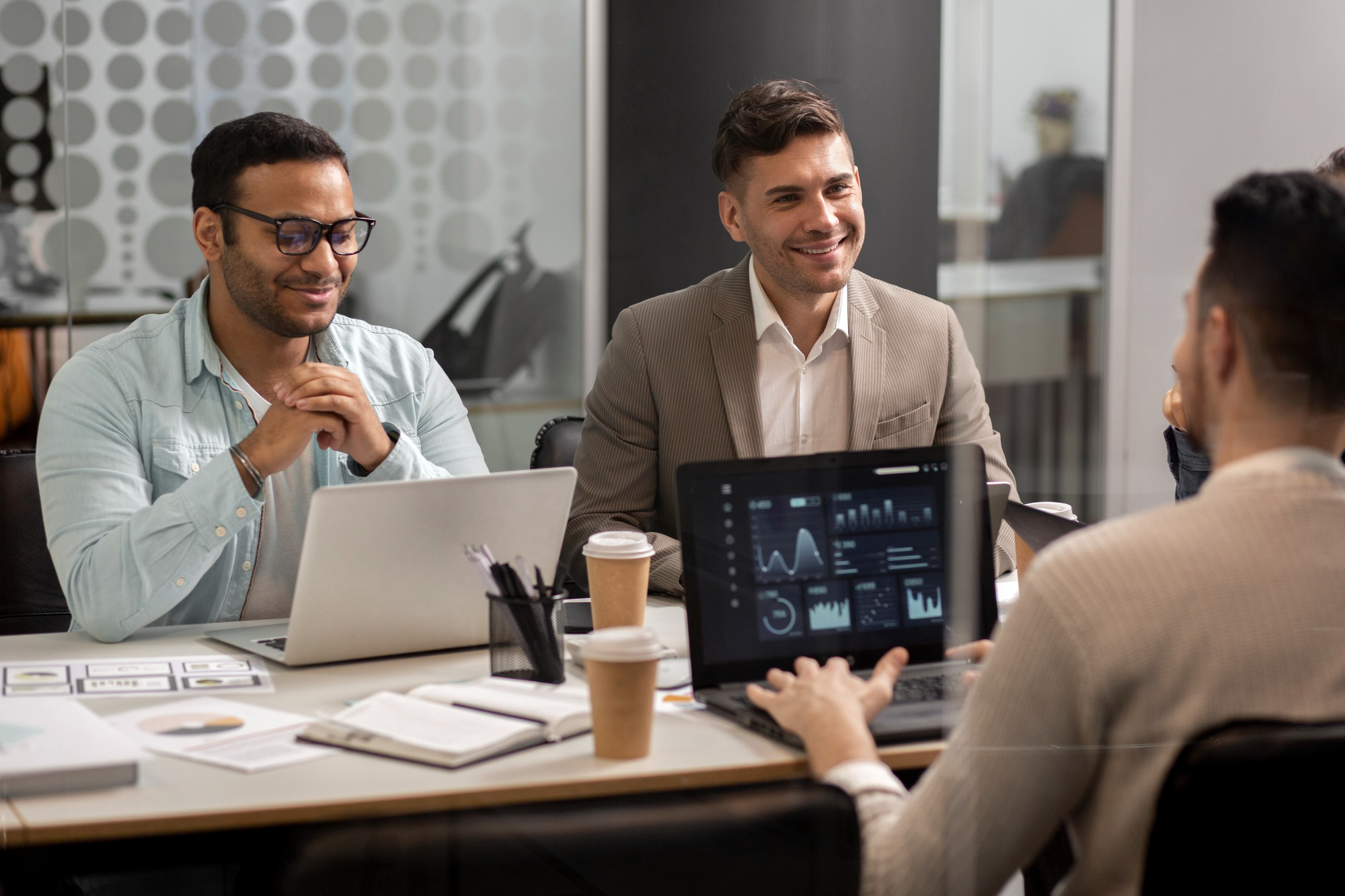 Team reviewing AI analytics on laptop